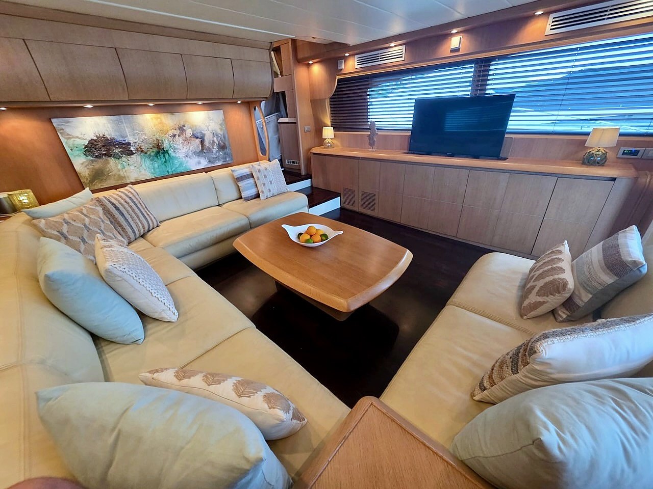 Salon of the Limitless yacht with designer sofa and artwork