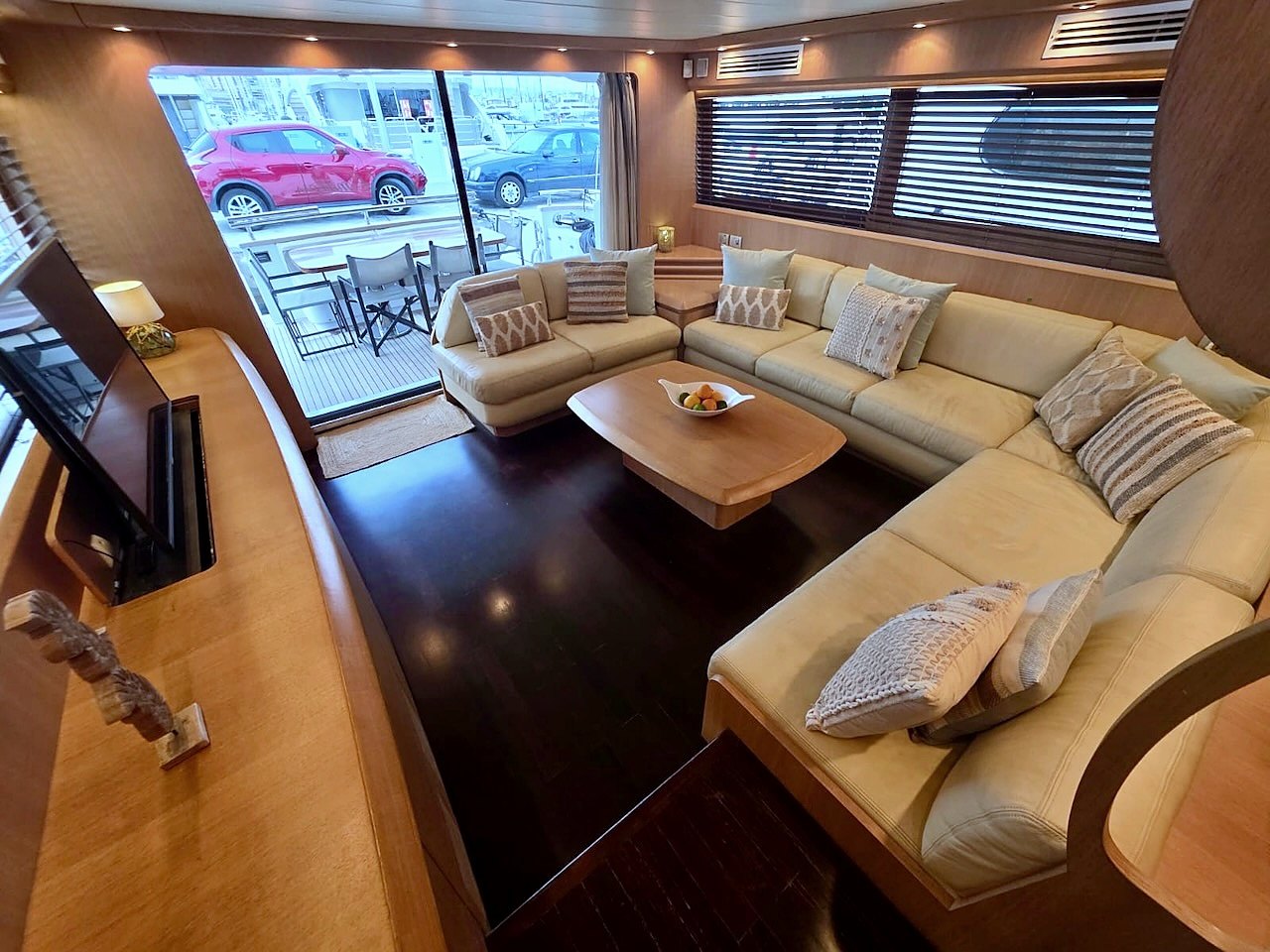 Salon lounge of the Limitless yacht with marina views