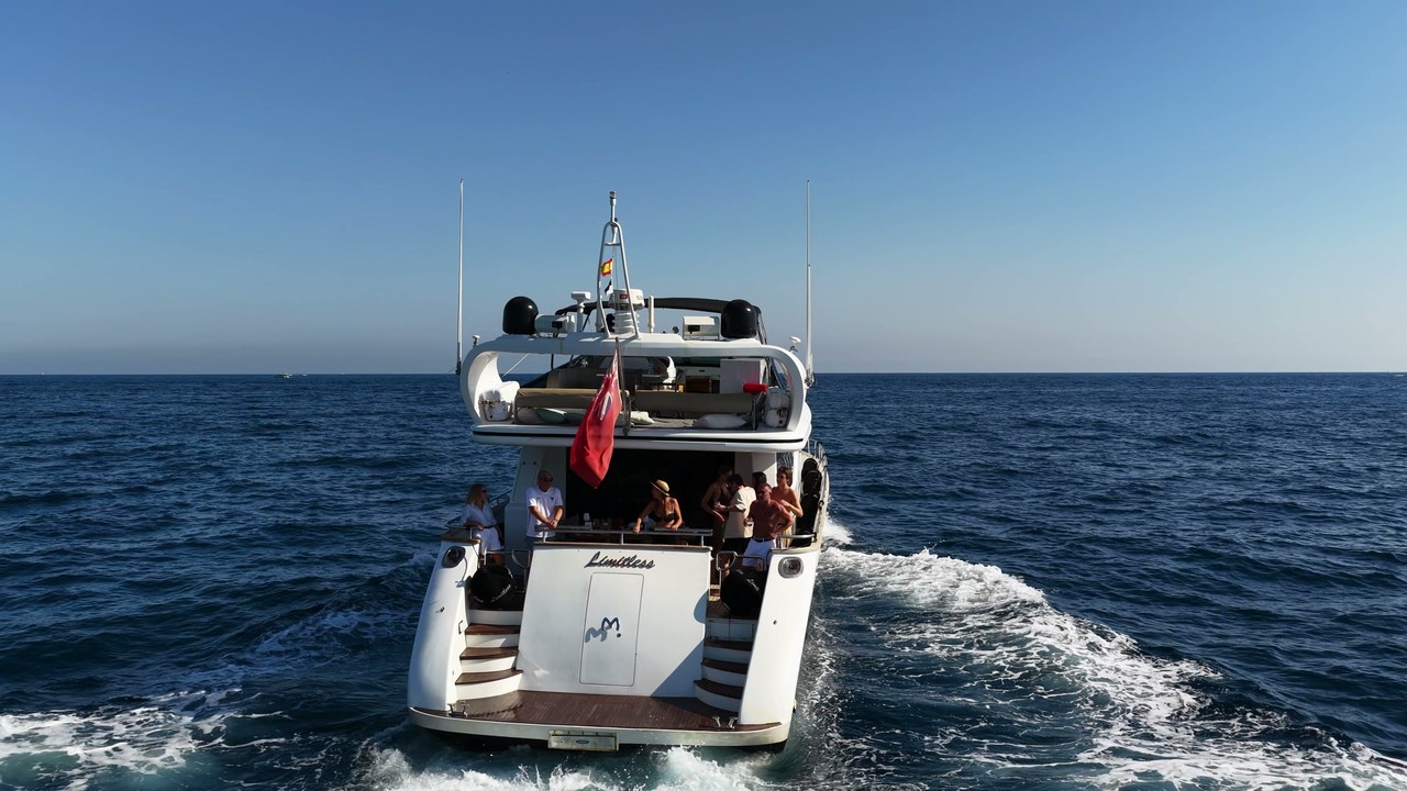 Guests socialising on the aft deck of Limitless underway