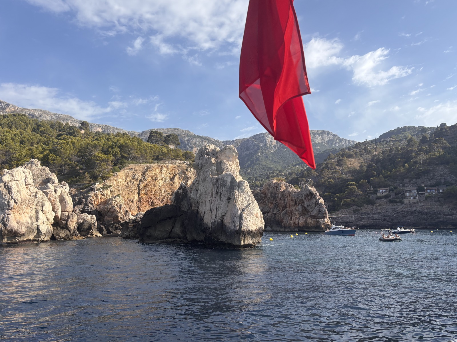 Portals Vells rock formations from Limitless with the red ensign flying