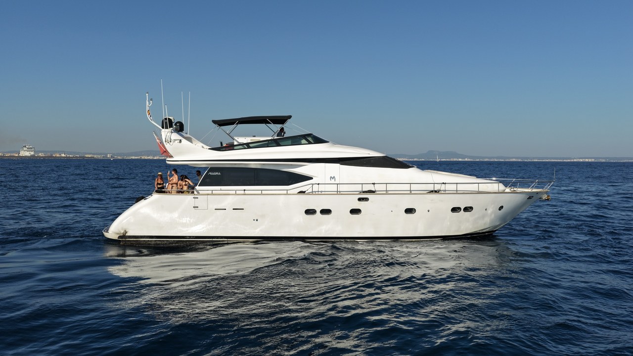 Side profile of the Limitless yacht cruising on calm open sea